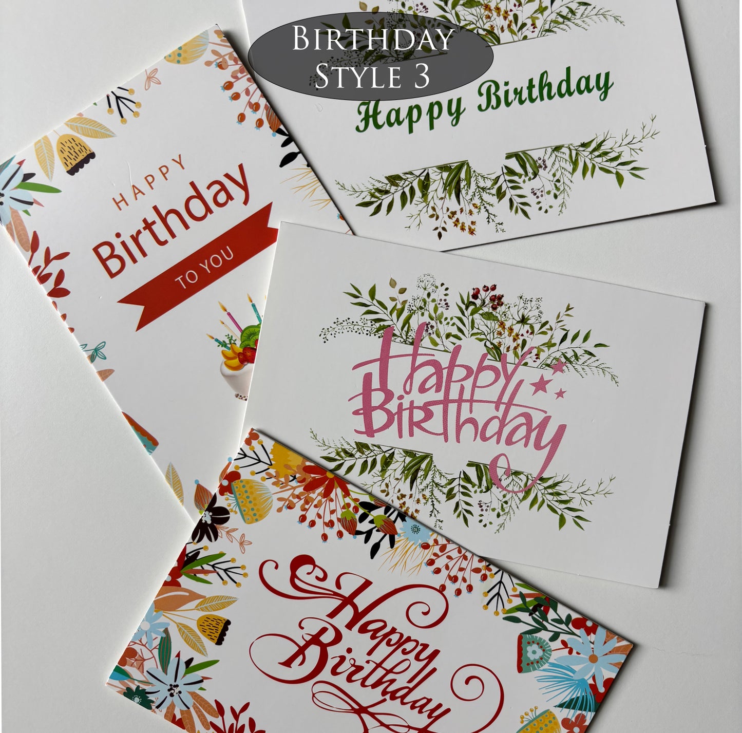 Four birthday cards with different floral designs on a gray background